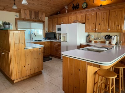 Kitchen from the living  room - TV in the corner to enjoy while you cook!